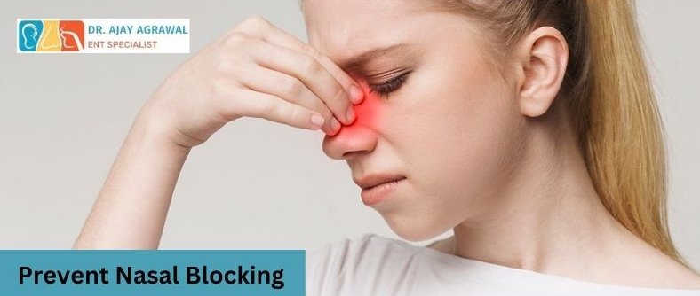 A woman touches her nose, which is highlighted red, looking uncomfortable. A blue box contains the text "Prevent Nasal Blocking". The logo and name of Dr. Ajay Agrawal, ENT Specialist, are also included.