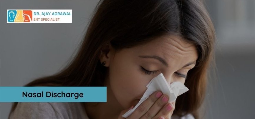 A woman sneezes into a tissue. A blue box contains the text "Nasal Discharge". The logo and name of Dr. Ajay Agrawal, ENT Specialist, are also included.